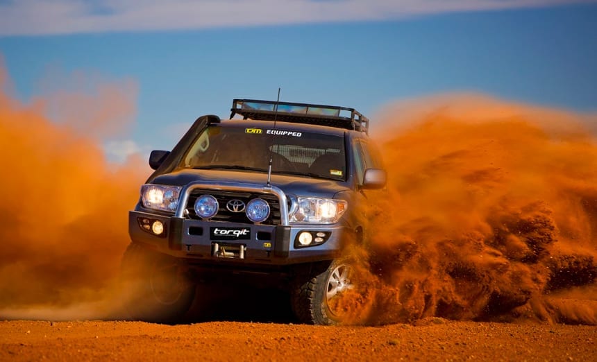 Toyota LandCruiser kicking up red dirt during the Finke Desert Race with Torqit exhaust upgrade