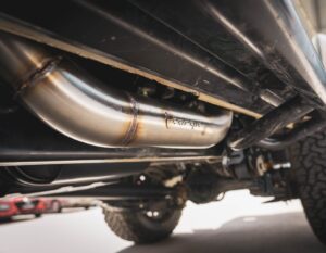 Close-up view of Torqit DPF-Back Exhaust system installed under Toyota LandCruiser 76/78 Series.
