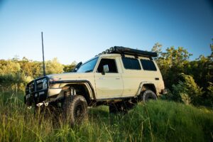 Toyota LandCruiser Troopy with Torqit exhaust in green paddock