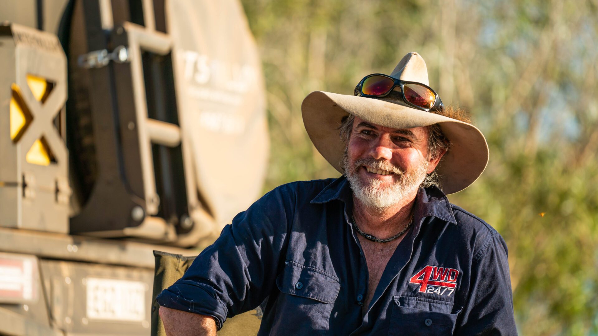 Graham Cahill smiling in a wide-brimmed hat beside his 4WD on Bob’s Track