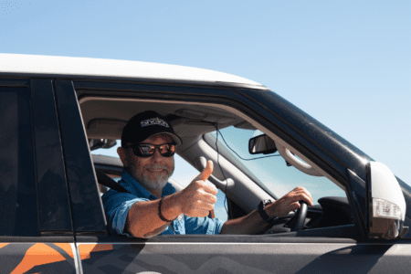 Graham Cahill giving a thumbs up while driving a 4WD in Western Australia.