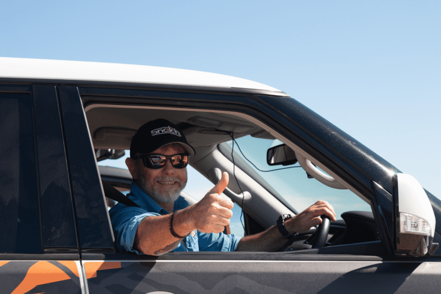 Graham Cahill giving a thumbs up while driving a 4WD in Western Australia.