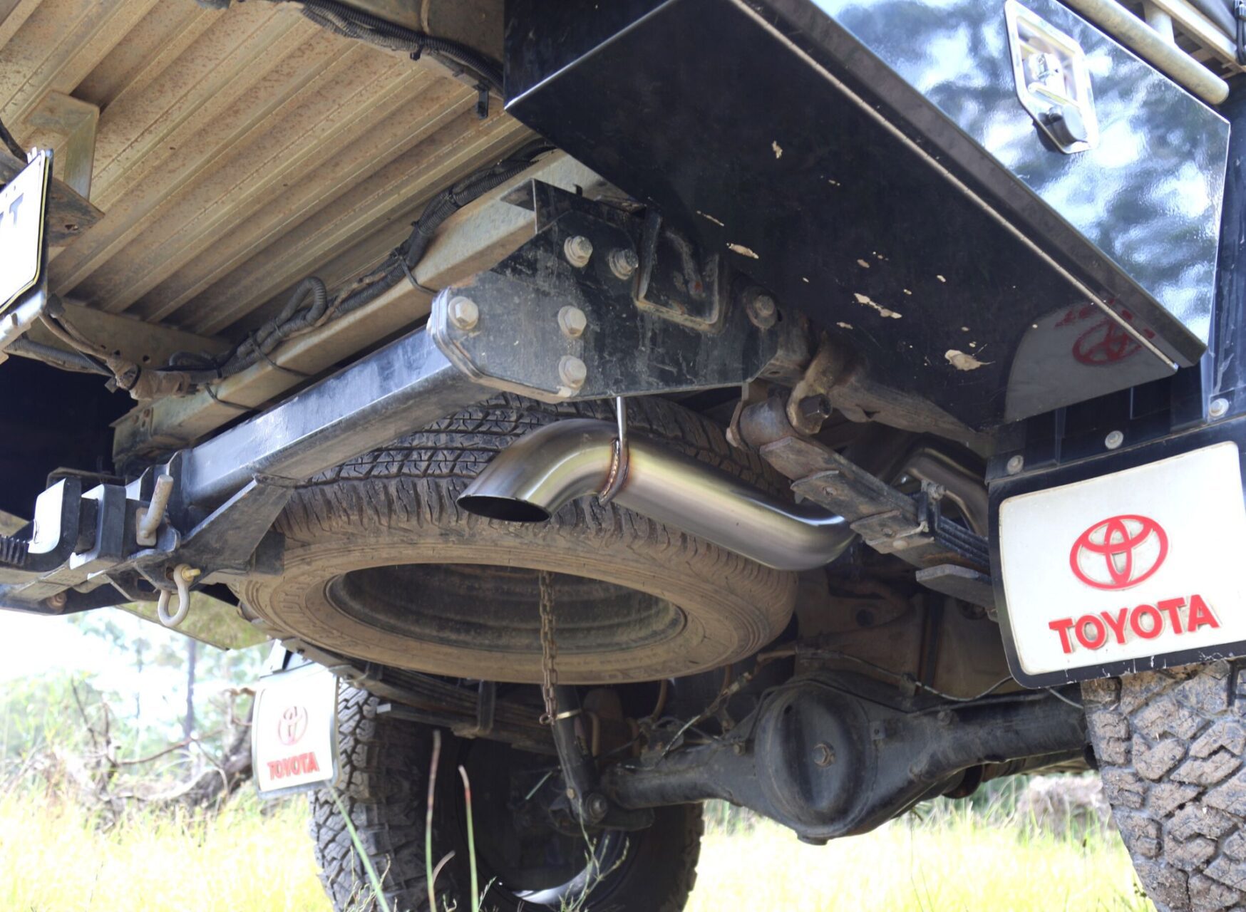 Turbo-back Hilux exhaust system installed under Toyota Hilux with Torqit branding