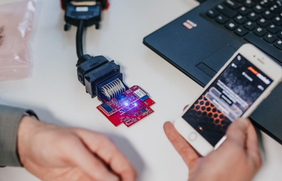Torqit Power Module connected with smartphone app and laptop