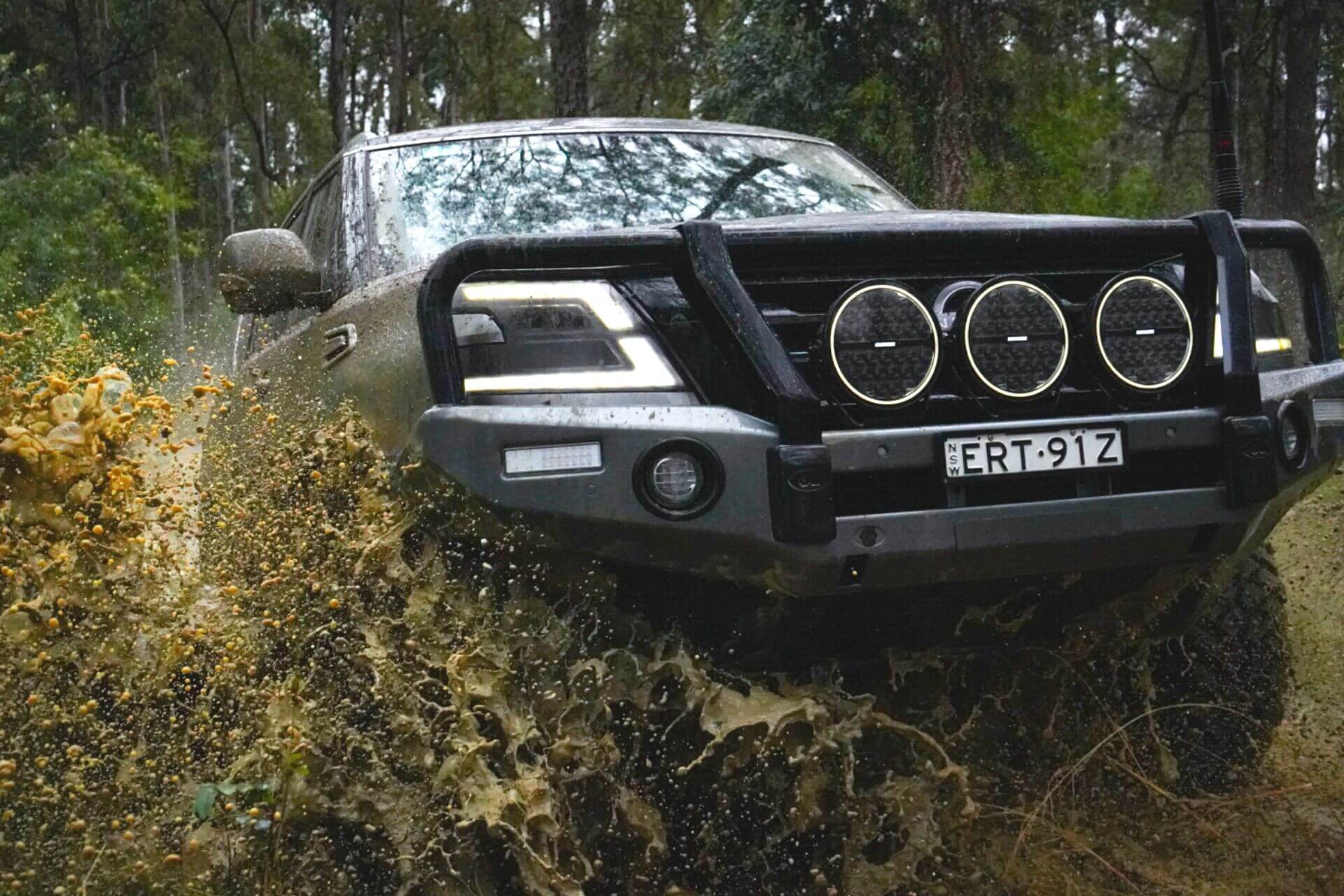 Nissan Y62 Patrol driving through muddy water during off-road testing with Torqit Pedal Torq Throttle Controller.