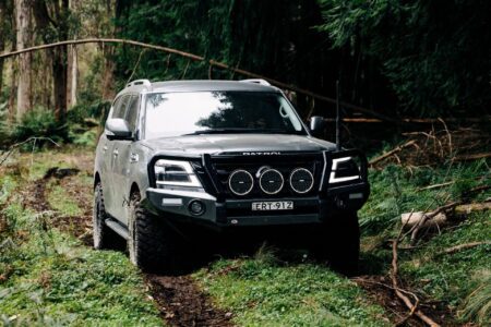 Y62 Nissan Patrol fitted with Torqit performance upgrades driving through a forest track.