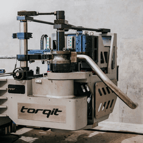 Torqit mandrel bender machine shaping an exhaust pipe.