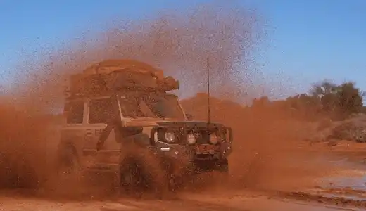 4WD Performance off-road vehicle driving through muddy terrain