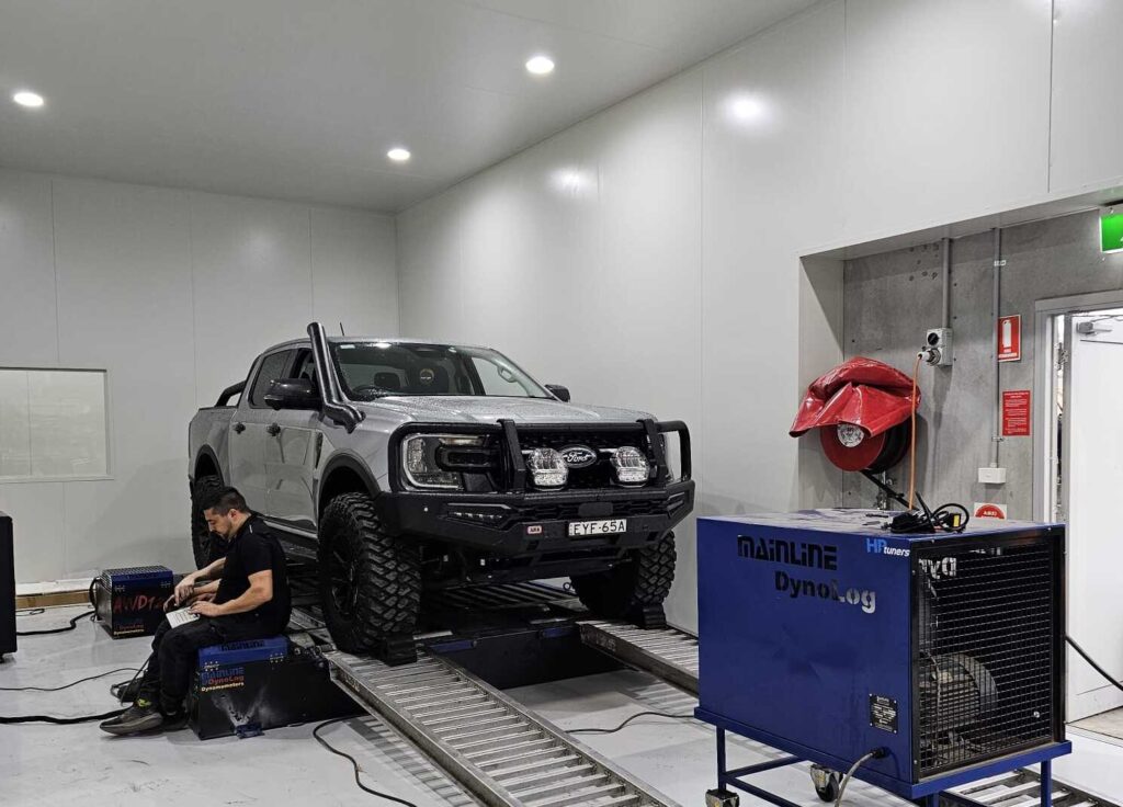 4WD vehicle undergoing dyno tuning test inside Torqit’s performance workshop