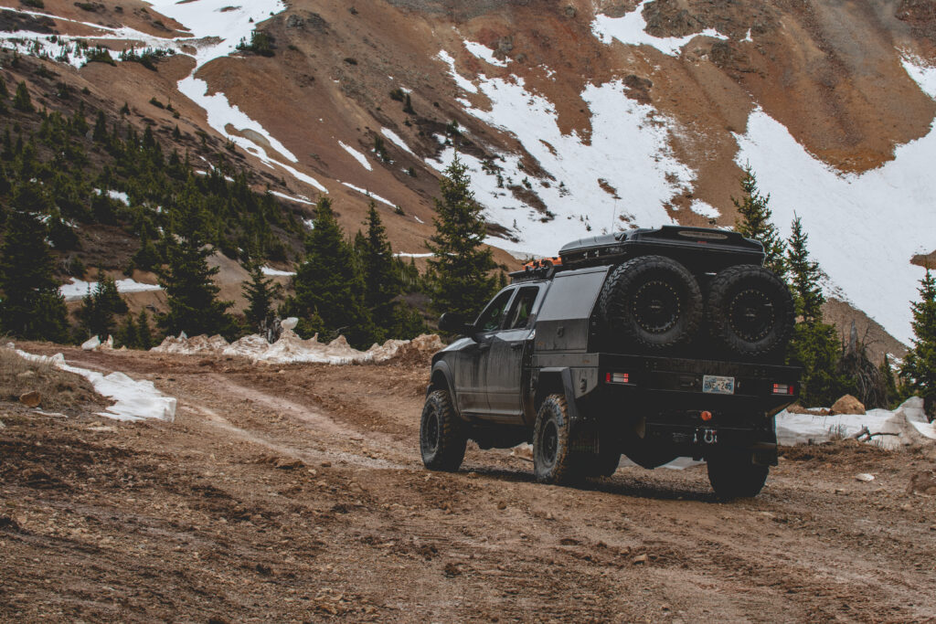 4WD vehicle driving off-road in the mountains promoting Torqit newsletter updates