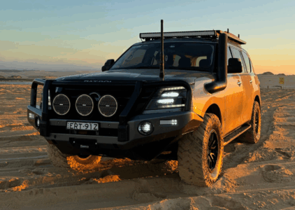 Upgraded 4WD fitted with Torqit performance parts driving across sand dunes.