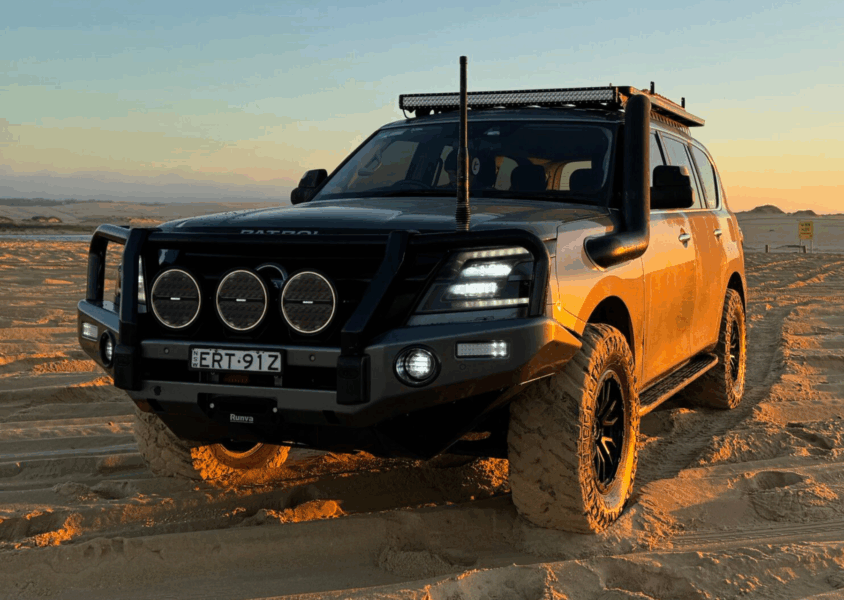Upgraded 4WD fitted with Torqit performance parts driving across sand dunes.