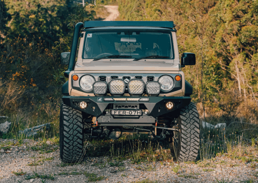 Upgraded Suzuki Jimny 4WD with Torqit performance enhancements on an off-road track.