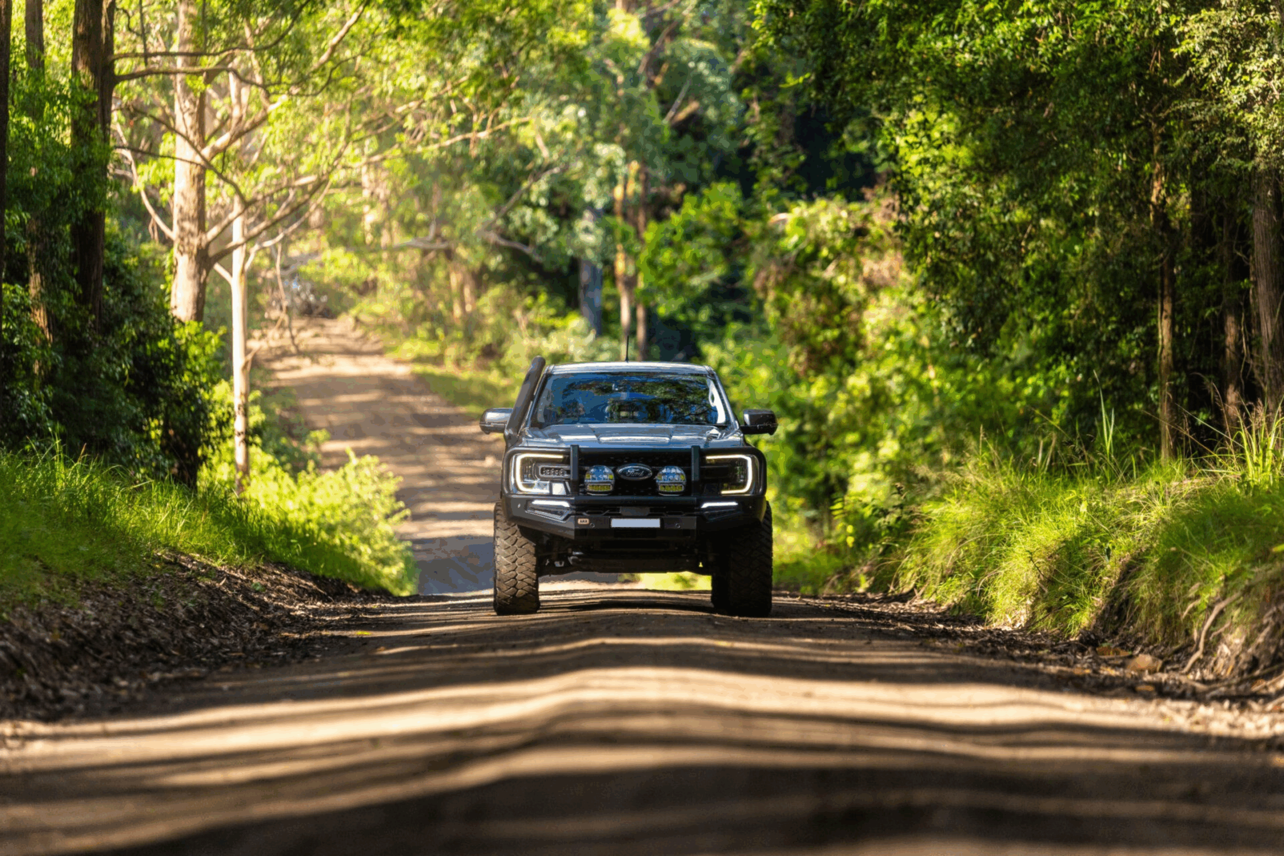 Black 4WD driving through a forest trail, representing Torqit Performance Centre builds and upgrades.