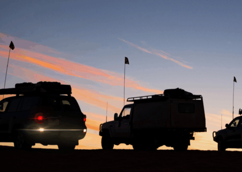 Off-road vehicles equipped with Torqit upgrades parked at sunset in the outback.